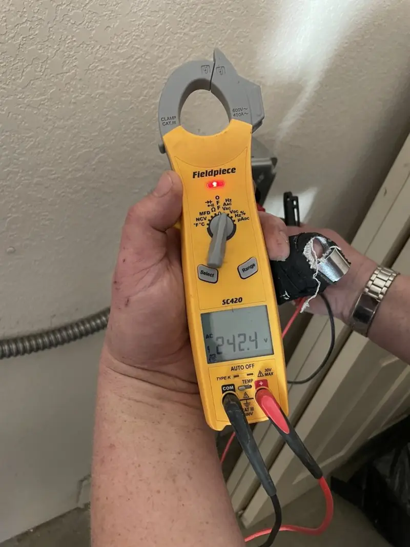 Voltage testing with clamp meter during Recessed Lighting Installation in Boothbay